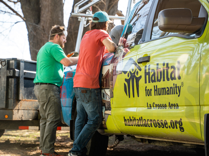 Habitat workers meeting next to truck