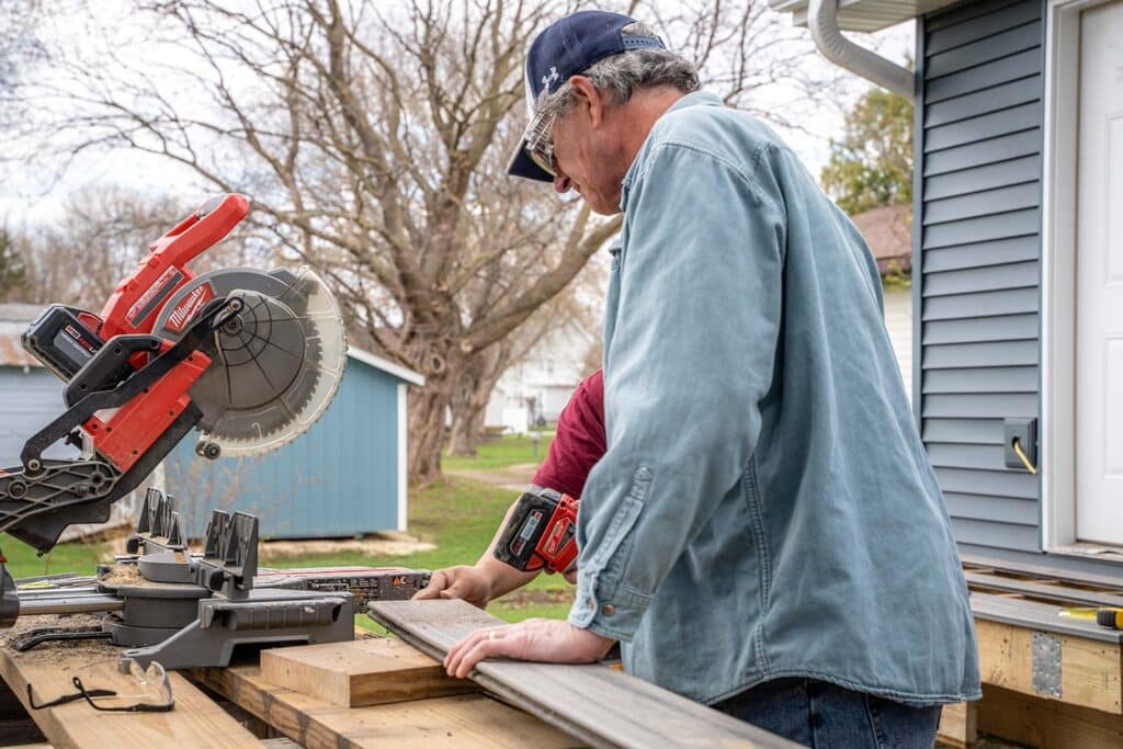 Worker using a mitre saw